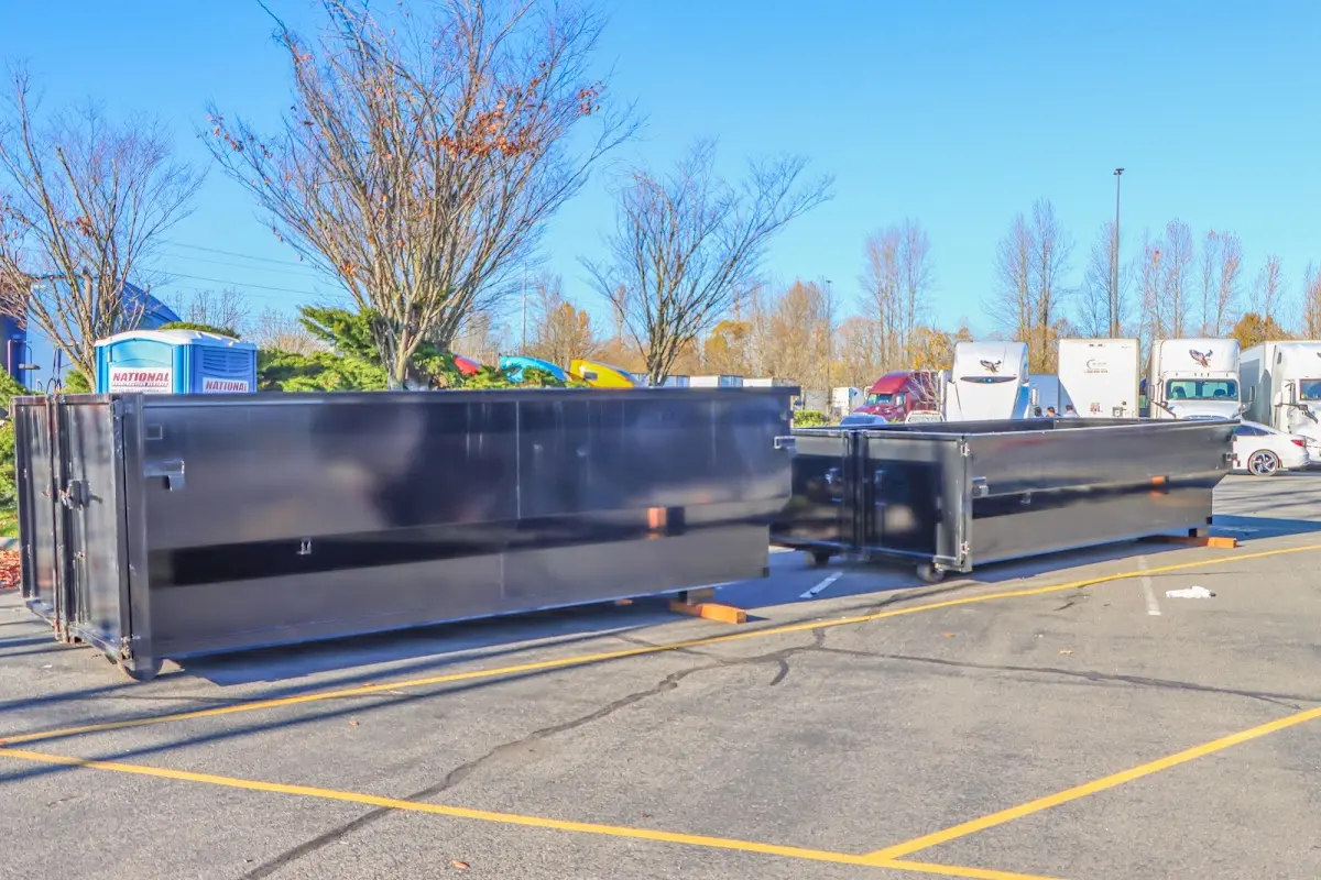 Professional dumpster rental service with roll-off container on residential driveway in Alderwood Manor